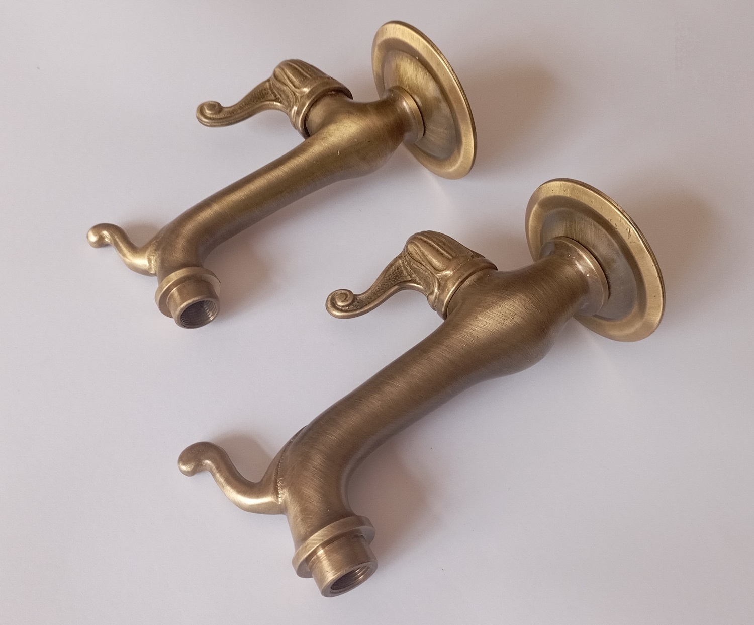 Decorative wall-mounted water spigots for exterior